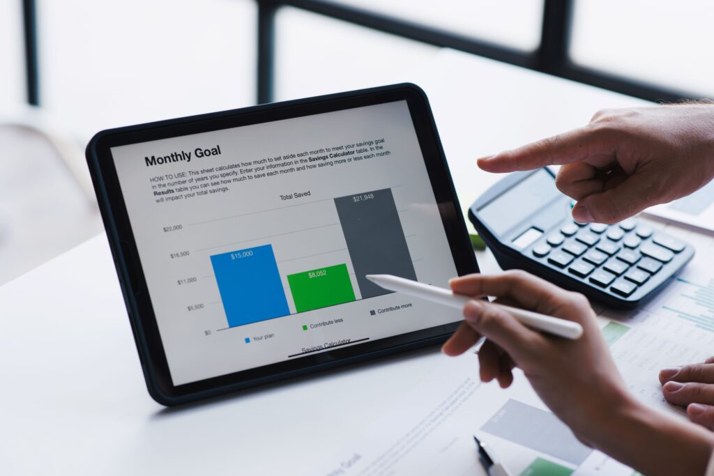 Person comparing financial options on a tablet with a savings calculator