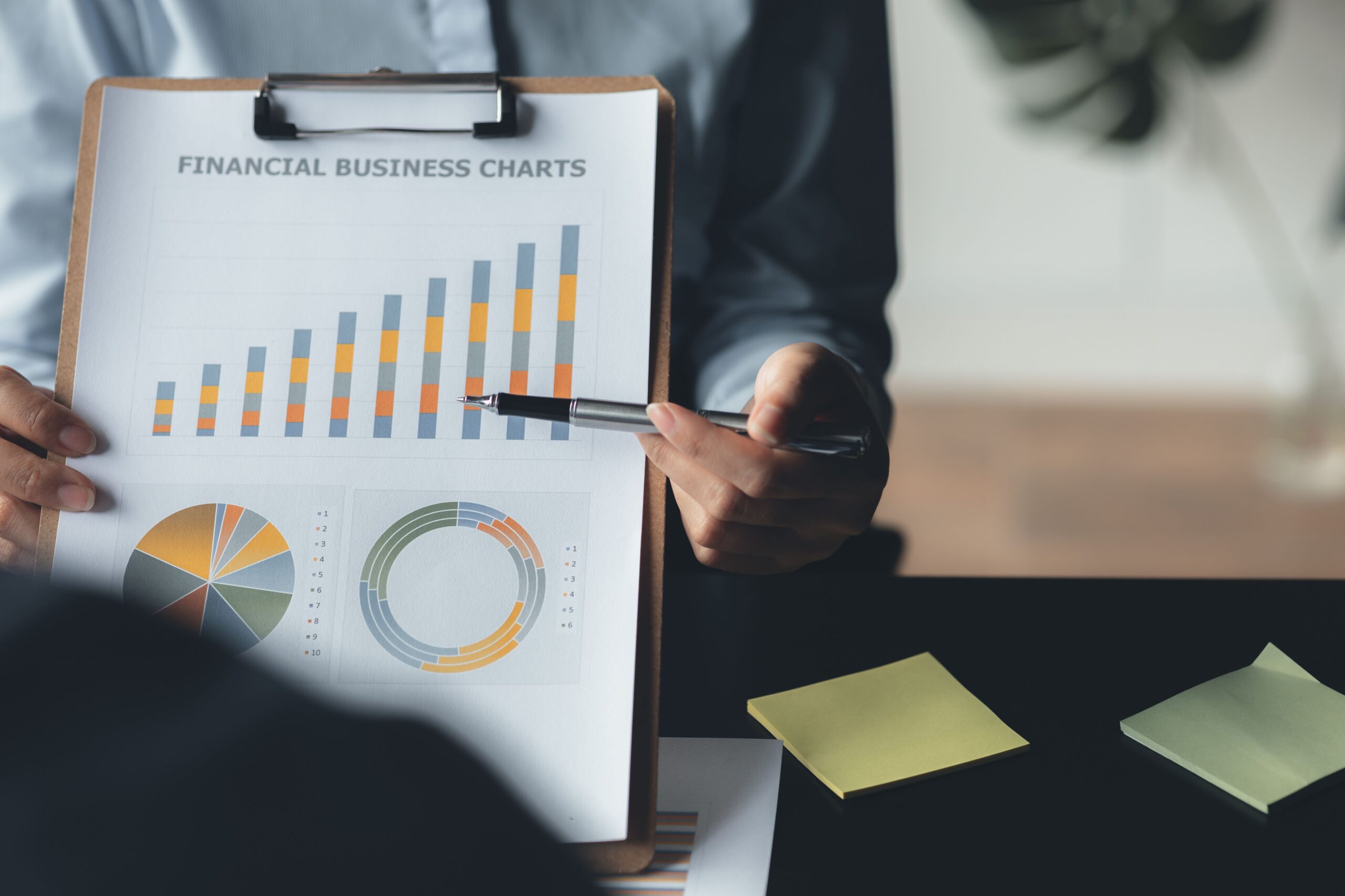 Business professionals reviewing financial charts and discussing strategic decisions, representing how tradelines are utilized in financial planning and credit management.
